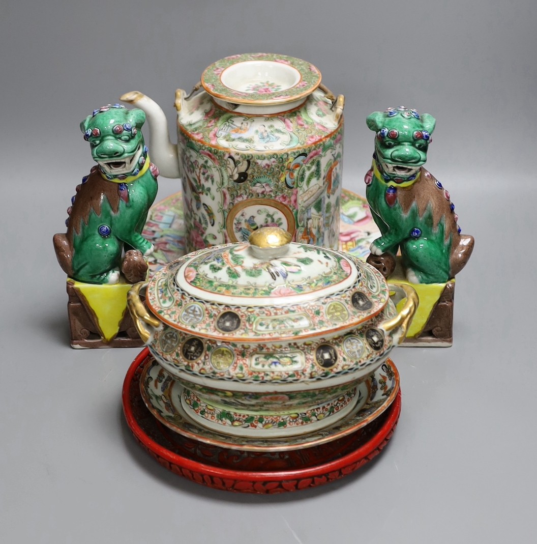 A Cantonese famille rose plate and teapot with cover, a pair of Chinese seated dogs, and a tureen with cover and oval dish, And a Chinese faux lacquer dragon and Phoenix dish, teapot 18 cms high